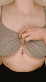 Signature fine line ornamental on the sternum