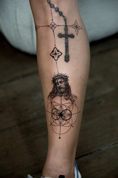 Delphin Musquet skillfully blends fine line and micro realism techniques to create a striking black and gray geometric Jesus tattoo.