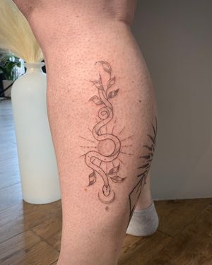 Experience the beauty of fine lines and geometric patterns in this stunning snake tattoo by Chloe Hartland.