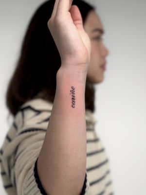 Get a timeless and sophisticated small lettering tattoo done by the talented artists at Saka Tattoo. Perfect for a subtle and personal touch to your body art.