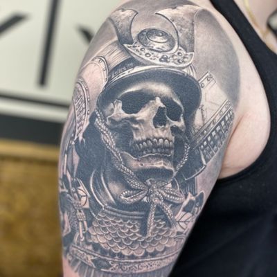 Experience the haunting beauty of a black and gray, realistic samurai skeleton tattoo by Gaston Gromnicki. This striking design combines traditional Japanese warrior spirit with a macabre twist.