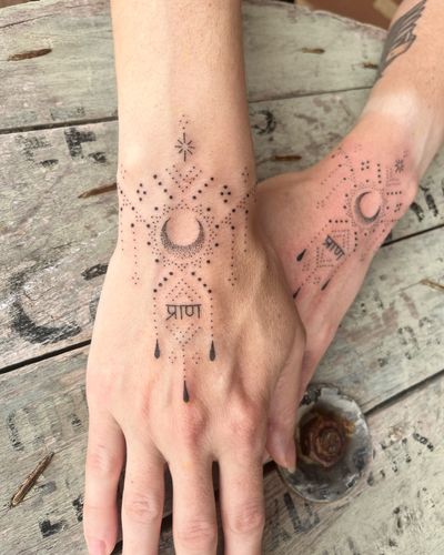 Get a celestial touch with this moon-inspired hand-poked dotwork design by Indigo Forever Tattoos. A unique addition to your body art collection.