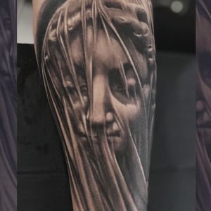 Elegant black and gray realism tattoo of a statue, expertly crafted by Gaston Gromnicki.