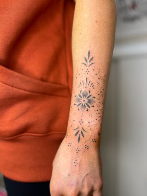 Beautiful hand-poked flower motif by Indigo Forever Tattoos, intricately created with dotwork technique