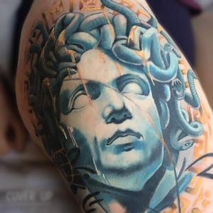 Transform your old tattoo into a stunning piece of art with this realistic Medusa cover up by renowned artist Gaston Gromnicki.