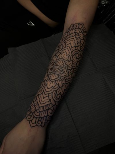 Get mesmerized by the intricate and detailed design of this ornamental tattoo created by the talented artist Lamat.