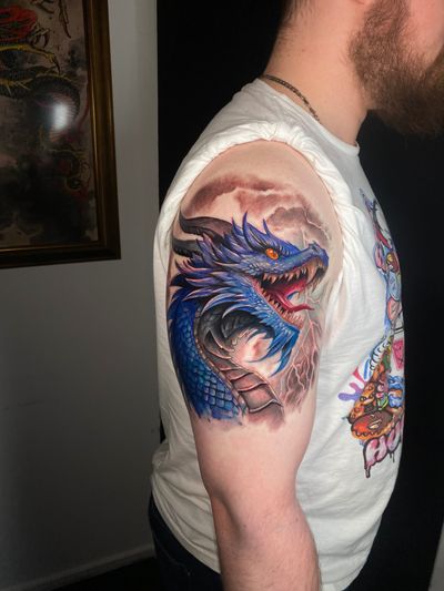 Experience the power and beauty of this vibrant illustrative dragon tattoo by the talented artist Marie Terry.