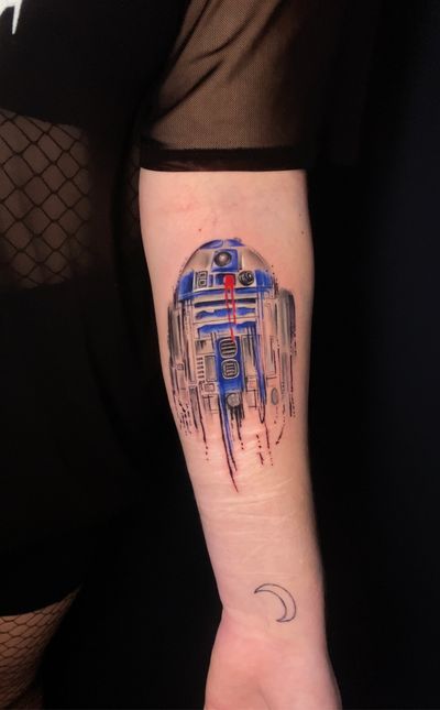 Capture the whimsical charm of Star Wars with this colorful R2-D2 tattoo by the talented artist Marie Terry. A unique twist on a classic motif.