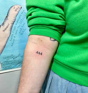 Get a unique hand-poked number tattoo by Charlotte Pokes, featuring small lettering for a minimalist look.