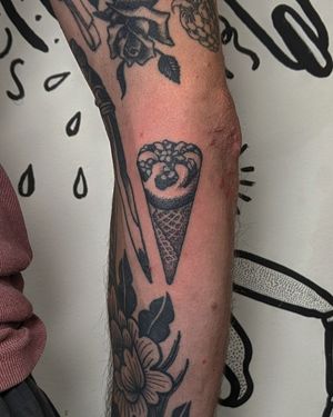 Embrace the sweetness of summer with this intricate blackwork and hand-poked tattoo of a tempting ice lolly and cornetto by Alien Ink.