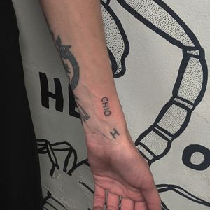Get inked by Alien Ink with this sleek and subtle small lettering tattoo design. Perfect for those who appreciate delicate and minimalist tattoos.