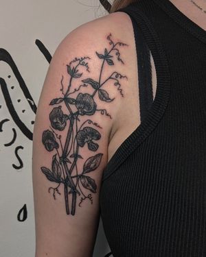 Experience the beauty of hand-poked blackwork and dotwork techniques in this detailed botanical flower tattoo by Alien Ink.