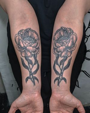 This blackwork and dotwork hand-poked tattoo features a beautifully detailed flower motif, expertly done by the talented artist at Alien Ink.