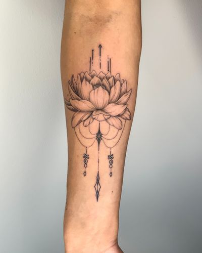 Black and grey lotus flower with ornamental jewellery tattoo.