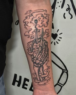 Get inked with a unique hand-poked blackwork tattoo featuring a surreal match and skeleton design. Done by Alien Ink.