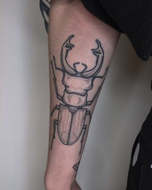 Get a unique blackwork, dotwork, hand_poke, and illustrative beetle tattoo expertly crafted by Alien Ink.