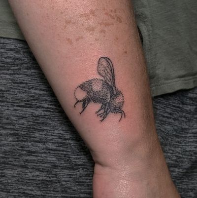 Get buzzed with this unique blackwork bee tattoo by Alien Ink, featuring intricate dotwork details. Hand-poked for a one-of-a-kind look.
