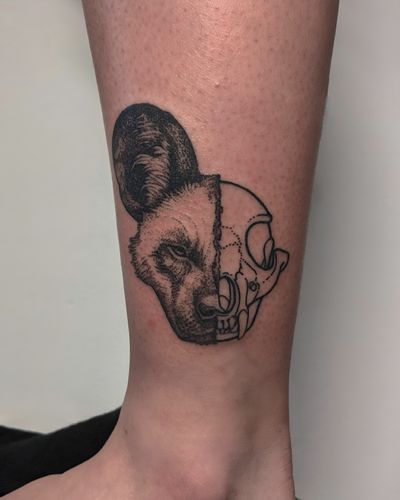 Discover a unique blackwork and hand-poked tattoo featuring a skull and hyena design, expertly crafted by Alien Ink.