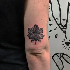 Get a stunning blackwork and dotwork maple leaf tattoo by Alien Ink, created with unique hand-poked technique.