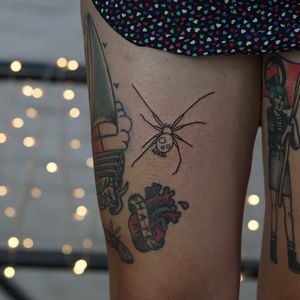 Get tangled in the dark allure of this ignorant style spider tattoo. Bold lines and intricate details crafted by Alien Ink.