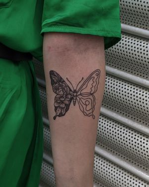 Get an illustrative dotwork tattoo of a butterfly and flower by Alien Ink, expert in hand-poke technique.