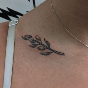 Get a unique and delicate olive branch tattoo done in dotwork style by Alien Ink, with the technique of hand poking for a stunning and one-of-a-kind design.