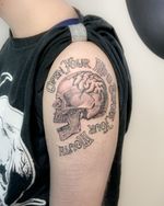 Black and grey realism skull with script