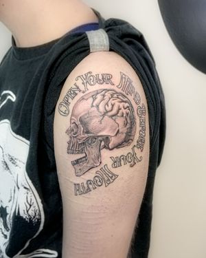 Black and grey realism skull with script