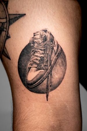 Get the ultimate sneaker tribute with this stunning black and gray micro realism tattoo of Jordans by Saka Tattoo.