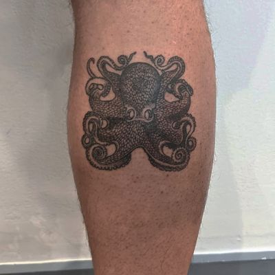 Get a unique hand-poked illustrative octopus tattoo by the talented artists at Alien Ink. Stand out from the crowd with this intricate design!