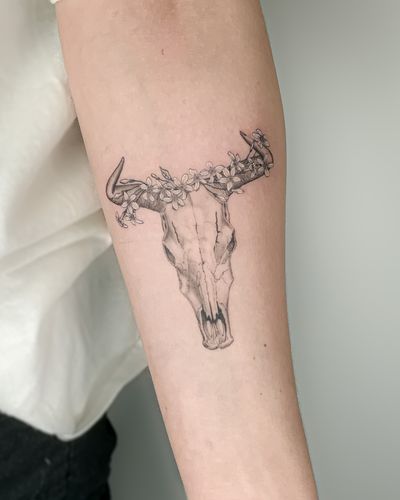 Black and grey realism bull skull with jasmine flowers of the horns