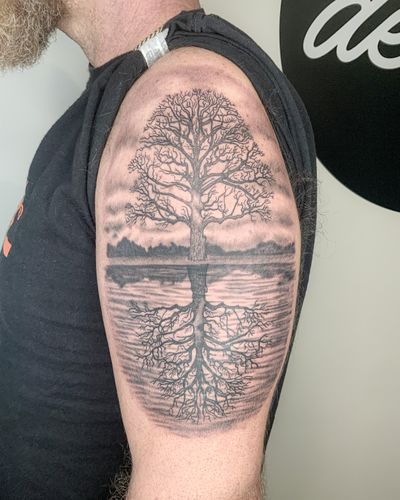 Black and grey realism tree on river bank