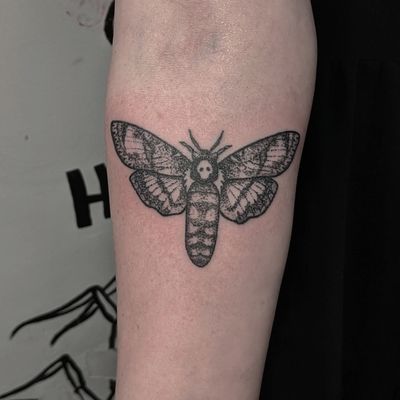 Get a unique hand-poked dotwork moth tattoo by Alien Ink. Delicate and intricate design for a timeless look.