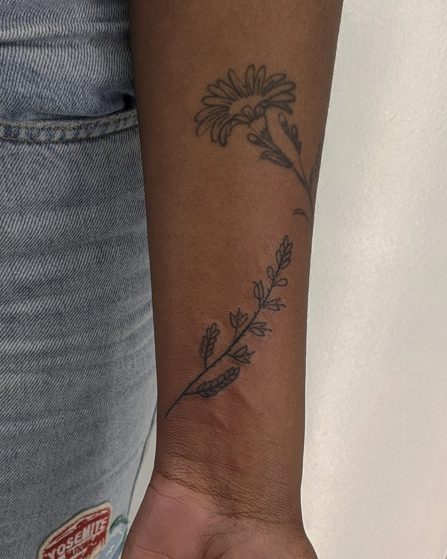 Looking to get the little arrow design covered. My tattoo artist doesn't  thing he can without later removal but I'm a bit wary about that. Anything  floral or nature based to go