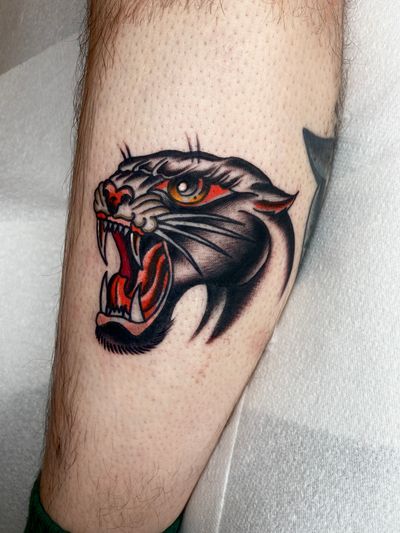 Get a fierce and timeless panther tattoo with bold lines and vibrant colors by the talented artist Flashbyaj.