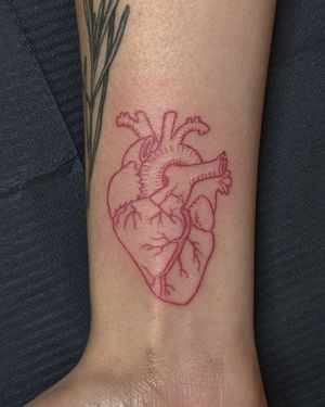 Get a beautifully detailed and vibrant red heart tattoo with fine line work done by Alien Ink's talented artists.