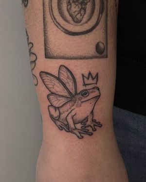 Get unique dotwork frog design by Alien Ink in illustrative style with hand poke technique. Stand out with this intricately designed tattoo!