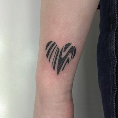 Discover the beauty of dotwork tattoos with this stunning blackwork heart design by the talented artists at Alien Ink.