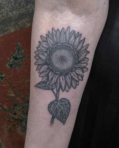 Get a unique illustrative sunflower tattoo by Alien Ink, created with delicate hand-poked dotwork technique.