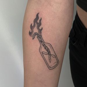 Unique dotwork and hand-poke style tattoo of a molotov cocktail by Alien Ink. A fiery and rebellious design for those who like edgy tattoos.