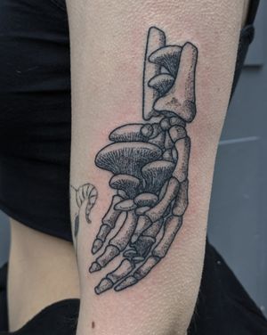 Get a unique illustrative tattoo of a skeleton hand done in dotwork style by Alien Ink for a bold and artistic look.