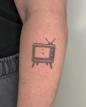 Fine line and illustrative tattoo by Alien Ink featuring a unique TV motif, perfect for any TV enthusiast.