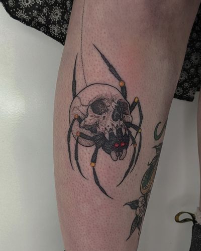 Unique hand-poked illustrative tattoo by Alien Ink, featuring a spider and skull design with intricate dotwork details.