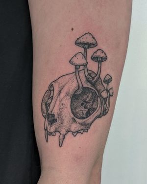 A unique hand-poked illustrative tattoo by Alien Ink combining a skull and mushroom motif in intricate dotwork style.