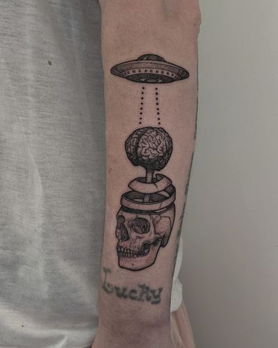Intriguing blackwork dotwork tattoo by Alien Ink featuring a skull, brain, alien, and UFO design.