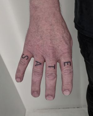 Get a beautifully crafted small lettering tattoo by the talented artists at Alien Ink. Express yourself with personalized text inked on your skin.