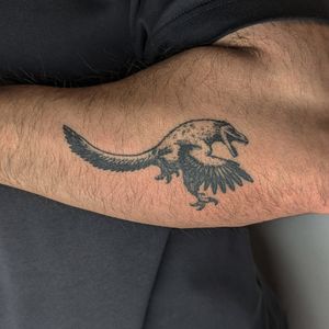 Get inked with a unique dinosaur design by Alien Ink, blending dotwork and illustrative styles.