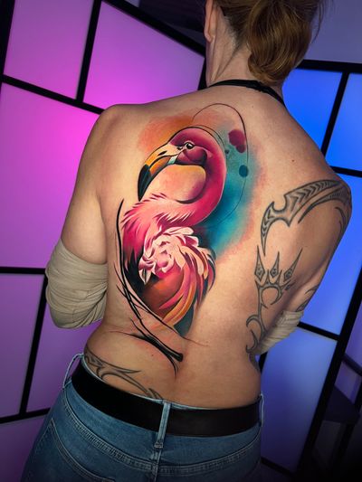 Experience the beauty of an illustrative flamingo tattoo by Cloto.tattoos, done in vibrant watercolor hues.