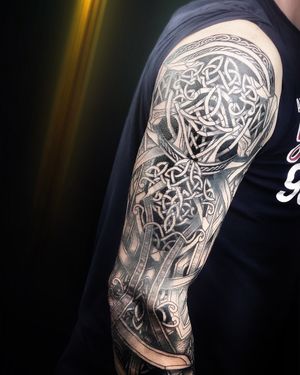 "This tattoo harmoniously marries the strength of Viking symbolism with a modern twist, a visual narrative etched in ink."
