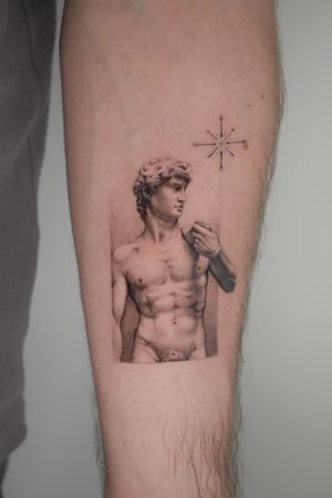 Captivating black and gray micro realistic tattoo of a statue by the talented artist Alexander Rufio.